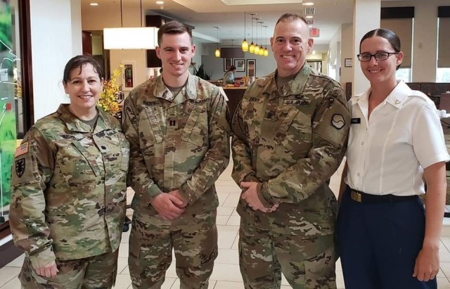 Lt. Col. Jennifer Rader, G3, 1st Theater Sustainment Command, her son, Capt. Greg Rader, her husband, Sgt. Maj. Alan Rader, S1 senior noncommissioned officer, 1st TSC, and their daughter, Pfc. Kayla Franza, visit the post exchange after her graduation from advanced individual training in 2019. Two of the Rader&#39;s three children serve in the Army, making it a family tradition.