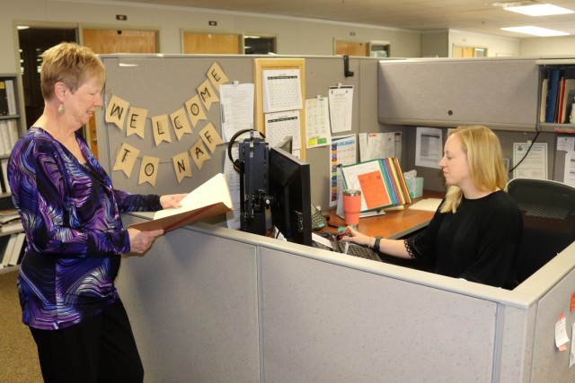 Human Resources Officer Paula Skinner (left) discusses business Aug. 4, 2021, with Human Resources Specialist Kate Sharp at office for the Fort McCoy Non-Appropriated Fund Civilian Personnel Advisory Center in building 2187 at Fort McCoy, Wis. The office recently received a high audit score that was among the best in the Army for non-appropriated fund CPACs. (U.S. Army Photo by Scott T. Sturkol, Public Affairs Office, Fort McCoy, Wis.)