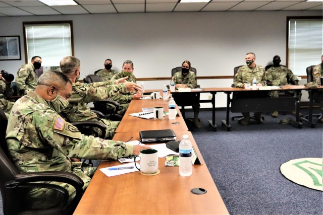 The 40th Chief of Staff of the U.S. Army Gen. James McConville (left) and other distinguished visitors listen as Fort McCoy Garrison Commander Col. Michael Poss gives a briefing Aug. 11, 2021, about the installation at the Fort McCoy (Wis.)...