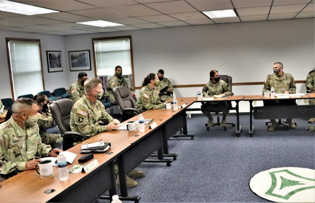 The 40th Chief of Staff of the U.S. Army Gen. James McConville (left) and other distinguished visitors listen as Fort McCoy Garrison Commander Col. Michael Poss gives a briefing Aug. 11, 2021, about the installation at the Fort McCoy (Wis.)...