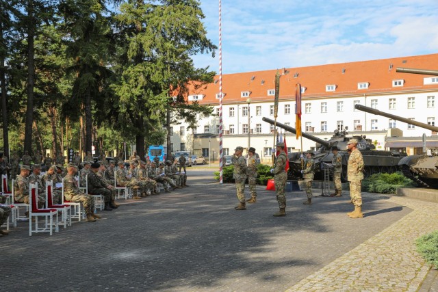 Incoming 1st Armored Brigade Combat Team, 1st Infantry Division leadership and outgoing 1ABCT, 1st Cavalry Division leadership stand at parade rest during the transfer of authority ceremony in Żagań, Poland, August 13, 2021. The 1ABCT, 1ID will...
