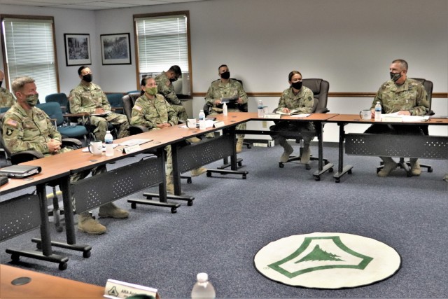 The 40th Chief of Staff of the U.S. Army Gen. James McConville (left) and other distinguished visitors listen as Fort McCoy Garrison Commander Col. Michael Poss gives a briefing Aug. 11, 2021, about the installation at the Fort McCoy (Wis.)...