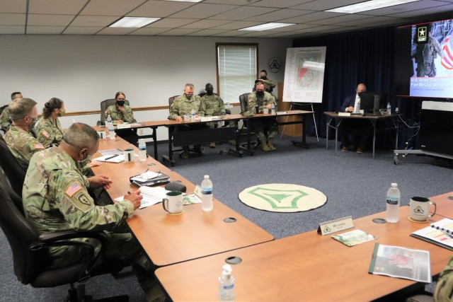 The 40th Chief of Staff of the U.S. Army Gen. James McConville (left) and other distinguished visitors listen as Fort McCoy Garrison Commander Col. Michael Poss gives a briefing Aug. 11, 2021, about the installation at the Fort McCoy (Wis.)...