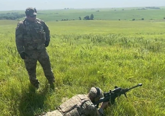 Staff Sgt. Jacob A. Barrett (left), a native of Marshall, Missouri, oversees standoff munitions disruption training on Fort Riley, Kansas, July 27. Soldiers from the 774th Ordnance Company (Explosive Ordnance Disposal) used a M107 sniper rifle to target and eliminate explosives at a distance during the training.  U.S. Army photo by Sgt. Joshua S. Oh, 1st Infantry Division Public Affairs.