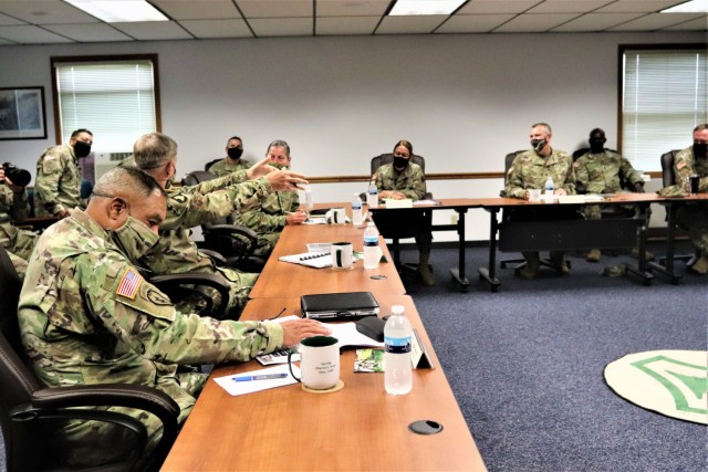 The 40th Chief of Staff of the U.S. Army Gen. James McConville (left) and other distinguished visitors listen as Fort McCoy Garrison Commander Col. Michael Poss gives a briefing Aug. 11, 2021, about the installation at the Fort McCoy (Wis.)...