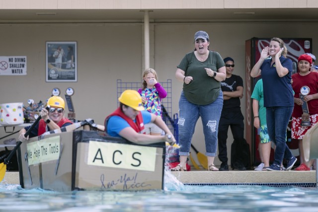 The Army Community Service boat sets sail during the Cardboard Regatta at Fort Bliss, Texas, Aug. 14, 2021. Bliss Family and Morale, Welfare and Recreation held the annual event, which challenged contestants to build two-person vessels out of corrugated cardboard and tape and keep them afloat during racing at the Community Pool on west Bliss.