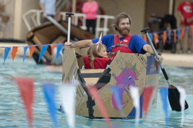 Competitors take to the water in the family division of the Cardboard Regatta at Fort Bliss, Texas, Aug. 14, 2021. Bliss Family and Morale, Welfare and Recreation held the annual event, which challenged contestants to build two-person vessels out of corrugated cardboard and tape and keep them afloat during racing at the Community Pool on west Bliss.