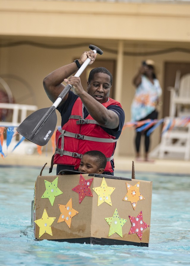 Competitors take to the water in the family division of the Cardboard Regatta at Fort Bliss, Texas, Aug. 14, 2021. Bliss Family and Morale, Welfare and Recreation held the annual event, which challenged contestants to build two-person vessels out of corrugated cardboard and tape and keep them afloat during racing at the Community Pool on west Bliss.