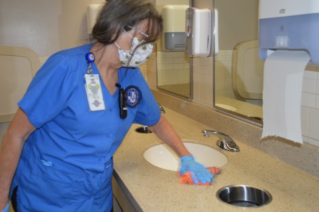 Helen Mann cleans using environmentally friendly products at Brooke Army Medical Center, Fort Sam Houston, Texas, Aug. 17, 2021. BAMC received the 2021 Practice Greenhealth Environmental Excellence award, which recognizes superior performance in environmental sustainability, covering a range of different sustainability programs and activities. (U.S. Army photo by Lori Newman)