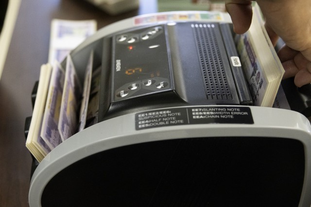 Spc. Saralin Moon, 326th Financial Management Support Center disbursing technician, counts simulated money during Diamond Saber at Fort McCoy, Wisconsin, Aug. 14, 2021. Diamond Saber is a U.S. Army Reserve-led exercise that incorporates...