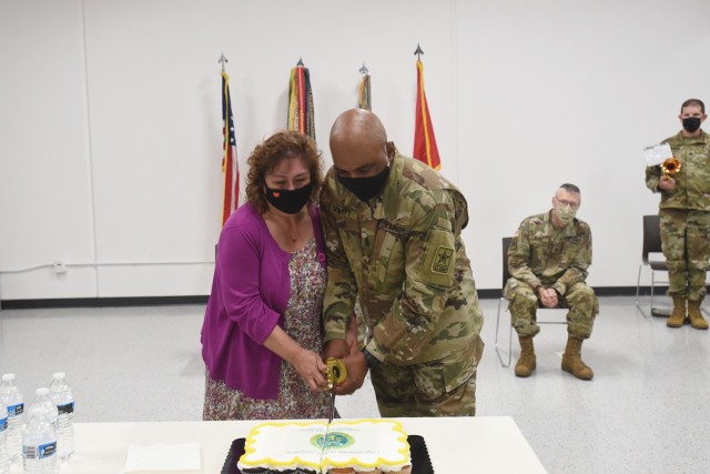 Command Sgt. Maj. Theodore H. Dewitt, outgoing command sergeant major for the 85th U.S. Army Reserve Support Command, along with his wife, Nancy, cut a ceremonial cake during his retirement ceremony, August 14, 2021. Dewitt retired from the U.S....