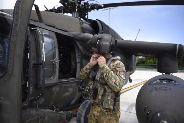 A U.S. Army Soldier with the 1st Battalion, 228th Aviation Regiment, Joint Task Force-Bravo, prepares to board a UH-60 Blackhawk helicopter at Grand Cayman, Cayman Islands, August 16. Helicopters with the 1-228 and personnel with JTF-Bravo...