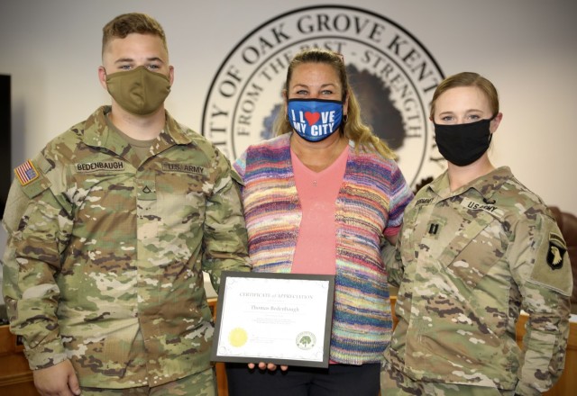 Pfc. Thomas Bedenbaugh, a Wheeled Vehicle Mechanic for Juliet Forward Support Company, 2nd Battalion, 506th Infantry Regiment, 3rd Brigade Combat Team, 101st Airborne Division (Air Assault) pose for a picture with Theresa Jarvis, Mayor of Oak...