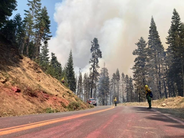 Magenta fire retardant covers the road as service members with California National Guard’s Task Force 578 fight the Dixie Fire as part of the mutual aid system in support of CAL FIRE, Aug. 16, 2021, in Northern California. (U.S. Army National...