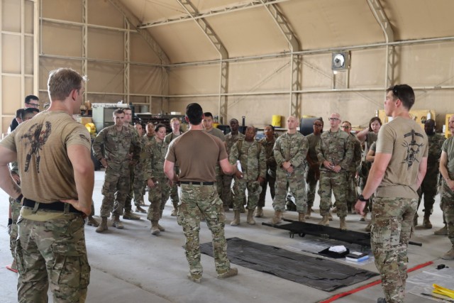 Soldiers assigned to 434th Chemical Company, 1st Battalion, 194th Armor Regiment, Task Force Bastard, listen as Sailors from CBRN Assessment and Response Team, CENTCOM-Enabling Support Package, walk them through the decontamination process during joint interoperability training August 12, 2021 at Camp Arifjan, Kuwait. (U.S. Army photo by Staff Sgt. Marc Heaton, Task Force Spartan Public Affairs)