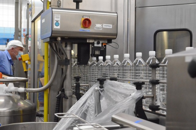Bottles of water make their way down an automated conveyer belt that first produces the bottles, then later bottles the water on one streamlined system. The water and ice plant at Gruenstadt bottles approximately 4.1 million gallons of water a year.