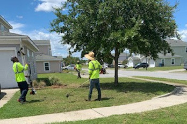 Contracted grounds maintenance crews work to maintain a yard in Family housing, Aug. 13 on Fort Stewart. Fort Stewart-Hunter Army Airfield Family Homes residents will notice an uptick in grounds maintenance crews since the town halls took place. As a result of their feedback, BBC has arranged for additional resources and more frequent mowing schedules. (Courtesy photo)