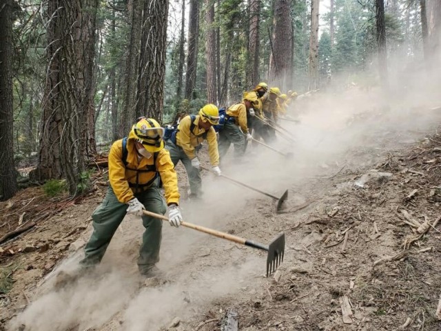 A handcrew from the California National Guard's Joint Task Force 578 fights the Dixie Fire as part of the mutual aid system in support of CAL FIRE, Aug. 16, 2021, in Northern California.