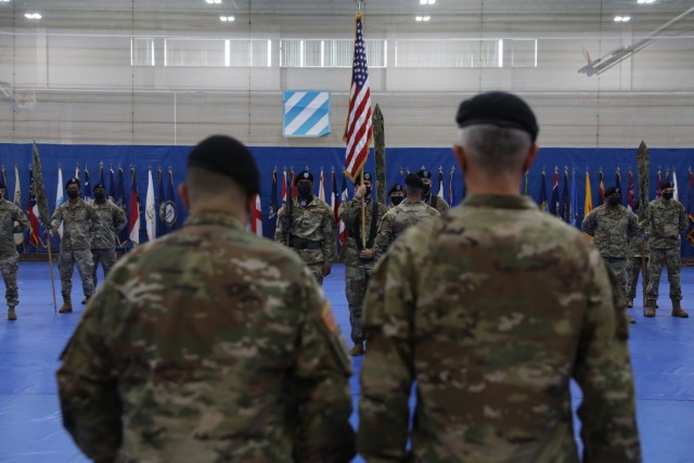 Col. Jeffery L. Reibestein the commander of the 16th Field Hospital, and Lt. Col. Edgardo Ramirez the 14th Field Hospital’s commander, prepare to sing the Dog Face Soldier anthem during the 14th FH activation and assumption to command ceremony...