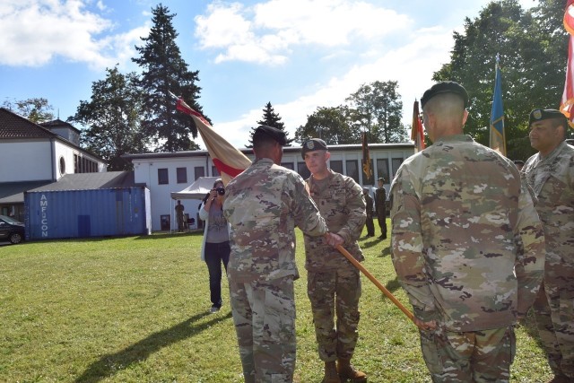 New Wiesbaden Garrison Command Sergeant Major Richard Russell accepts the Garrison colors from Garrison Commander Col. Mario Washington during the Change of Responsibility ceremony Aug. 20 on Clay Kaserne.