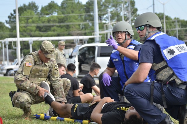 Fort Campbell Emergency Medical Services personnel evaluate a victim’s condition Aug. 17 following an active shooter scenario at Building 6563, which was conducted as part of a full-scale exercise.