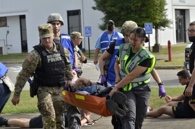 Fort Campbell Military Police and Emergency Medical Services personnel work together to carry a victim to an ambulance following an active shooter scenario Aug. 17 at Building 6563, which was conducted as part of a two-day full-scale exercise.