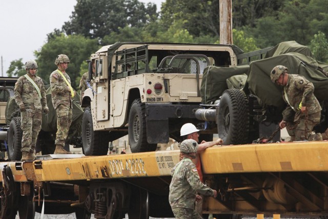 Soldiers and civilian employees team up to secure vehicles Aug. 16 at the Campbell Rail Operations Facility in support of 3rd Brigade Combat Team’s upcoming Joint Readiness Training Exercise rotation at Fort Polk, La.