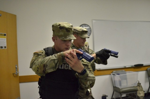 Corporal Kyle Crotty, 561st Military Police Company, 716th Military Police Battalion, left; and Sgt. Jason Wright, collision investigator, Installation Provost Marshal Office, secure a room at Building 6563 Aug. 17 during an active shooter scenario, which was conducted as part of a two-day full-scale exercise.