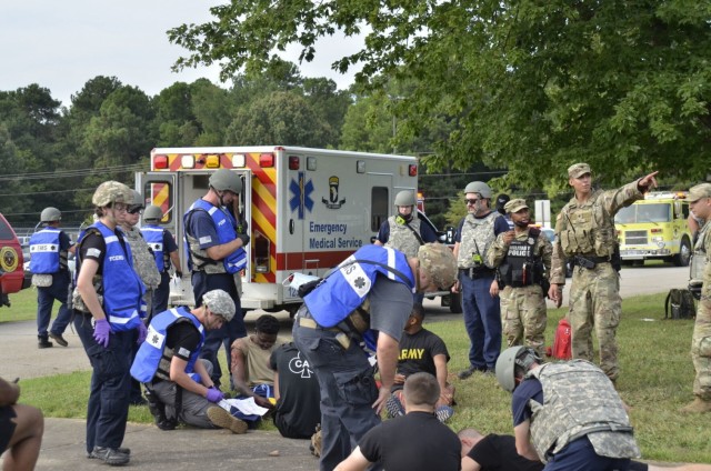 Fort Campbell Military Police and Emergency Medical Services personnel coordinate to make sure victims receive critical care following an active shooter scenario Aug. 17 at Building 6563, which was conducted as part of a two-day full-scale exercise.