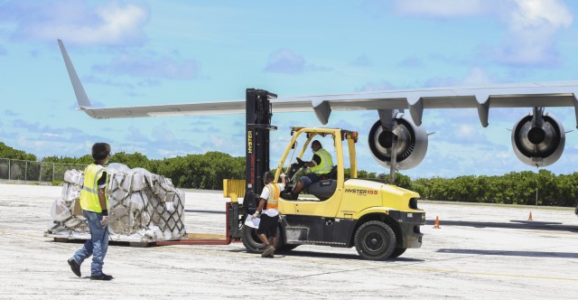 Airfield employees at Bucholz Army Airfield prepare to load cargo onto a C-17 during a routine operation on U.S. Army Garrison-Kwajalein Atoll Aug. 14, 2021.