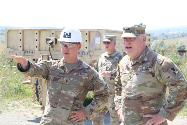 1st Lt.  John Murphy with the 301st FEST-M showcases a Resolute Castle construction project at the Joint National Training Capability in Cincu, Romania, a battalion-level maneuver training site, to 416th Theater Engineer Command Commanding General...