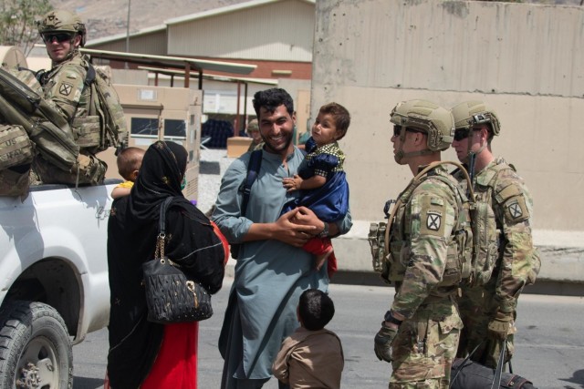 Soldiers with the 10th Mountain Division escort evacuees from the Hamid Karzai International Airport in Kabul, Afghanistan, Aug. 20. 