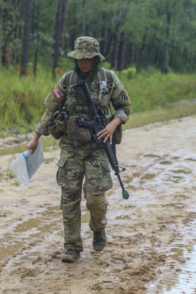 Spc. Lauren Coward, an Expert Infantry Badge candidate assigned to 1st Battalion, 28th Infantry Regiment, 3rd Infantry Division, at Fort Benning walks through a land navigation course at Fort Stewart, Georgia, Aug. 16, 2021. Daytime and nighttime land navigation are two of the events candidates must complete in order to qualify for the EIB or Expert Soldier Badge. (U.S. Army photo by Pvt. Elsi Delgado)