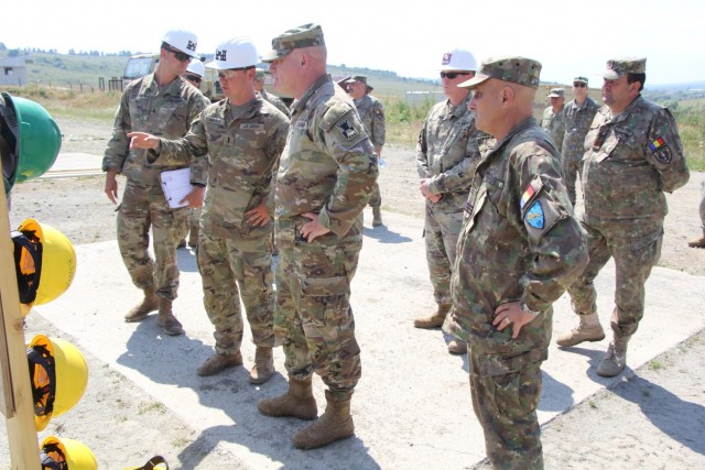 1st Lt. John Murphy with the 301st FEST-M showcases a Resolute Castle construction project at the Joint National Training Capability in Cincu, Romania, a battalion-level maneuver training site, to 416th Theater Engineer Command Commanding General...