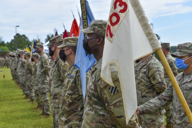 Soldiers assigned to the 3rd Infantry Division and additional units from Fort Jackson and Fort Myers stand in formation during an awards ceremony for Expert Infantry Badge and Expert Soldier Badge recipients at Fort Stewart, Georgia, Aug. 20, 2021. Candidates completed four days of intense testing in both rough weather conditions and a COVID-19 mitigation environment followed by a road march and a final tactical task on day five after two weeks of train-up to obtain the coveted badges. (U.S. Army photo by Spc. William Griffen)
