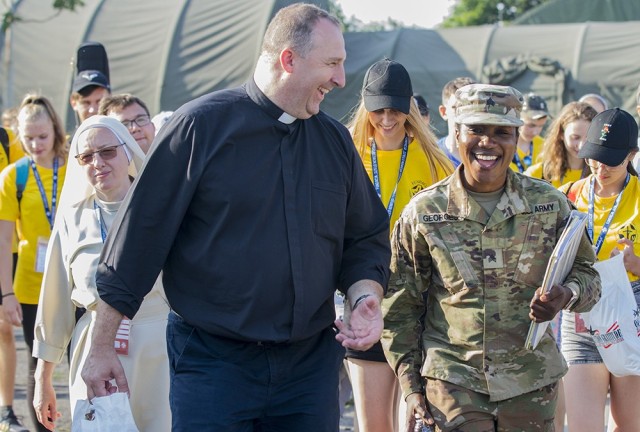 U.S. Army Sgt. Rose Georges leads a group of 41 recipients of the Pope John Paul II Scholarship and their chaperones during a tour of Forward Operating Site Powidz, Poland, July 13, 2021. Georges is an HR specialist deployed with the Florida...