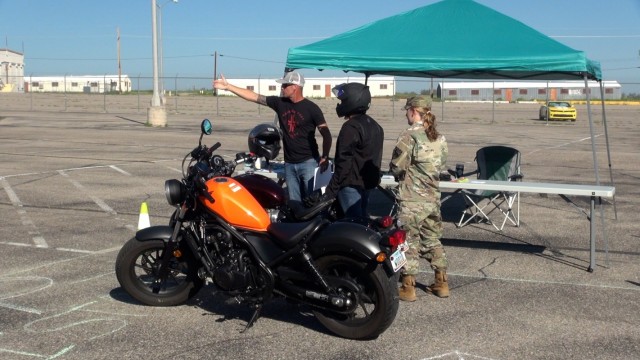 Joshua Polk, Deputy Director Safety, U.S. Army Intelligence Center of Excellence points Fort Huachuca, Ariz. motorcycle riders to the start of a Confidence Course and Show-N-Shine event.