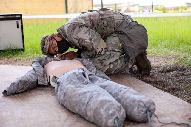 Spc. Rayquon Swanson, an Expert Infantry Badge candidate assigned to the 3rd Battalion, 15th Infantry Regiment, 2nd Armored Brigade Combat Team, 3rd Infantry Division, practices accessing a casualty during training week for the EIB at Fort Stewart, Georgia, Aug. 11, 2021.  Candidates completed four days of intense testing in both rough weather conditions and a COVID-19 mitigation environment followed by a road march and a final tactical task on day five after two weeks of train-up to obtain the coveted badges. (U.S. Army photo by Pfc. Summer Keiser)
