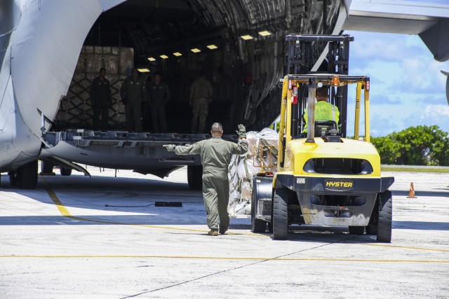 A C-17 crewmember assists in a cargo-loading operation at Bucholz Army Airfield Aug. 14, 2021. In one afternoon, the garrison received 18,000 pounds of incoming mail.