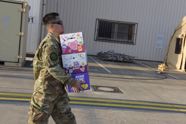 A U.S. Airman assigned to the 1st Combat Communications Squadron carries diapers to provide Afghan evacuee mothers at Ramstein Air Base, Germany, Aug. 20, 2021. Ramstein Air Base is providing safe, temporary lodging for qualified evacuees from Afghanistan as part of Operation Allies Refuge during the next several weeks. Operation Allies Refuge is facilitating the quick, safe evacuation of U.S. citizens, Special Immigrant Visa applicants and other at-risk Afghans from Afghanistan. Qualified evacuees will receive support, such as temporary lodging, food, medical screening and treatment and more at Ramstein Air Base while preparing for onward movements to their final destinations. (U.S. Air Force photo by Airman 1st Class Madelyn Keech)
