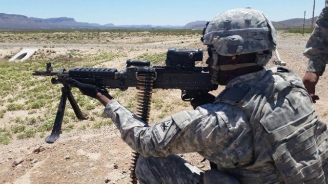 Staff Sgt. Auxtyne Omoregbee, a wideband satellite network coordinator from Headquarters, Headquarters Company, 53rd Signal Battalion, shoots an M-249 heavy machine gun at Fort Bliss, Texas, in 2015. Omoregbee was a combat medic stationed at Fort Bliss for three-and-a-half years before reclassing as a satellite systems operator. (Photo courtesy of Staff Sgt. Auxtyne Omoregbee/RELEASED)