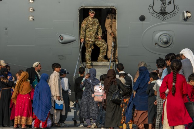 Service members prepare to board evacuees onto a C-17 Globemaster lll Aug. 22, 2021, at Al Udeid Air Base, Qatar. The Department of Defense is committed to supporting the U.S. State Department in the departure of U.S. and allied civilian personnel from Afghanistan, and to evacuate Afghan allies to safety.