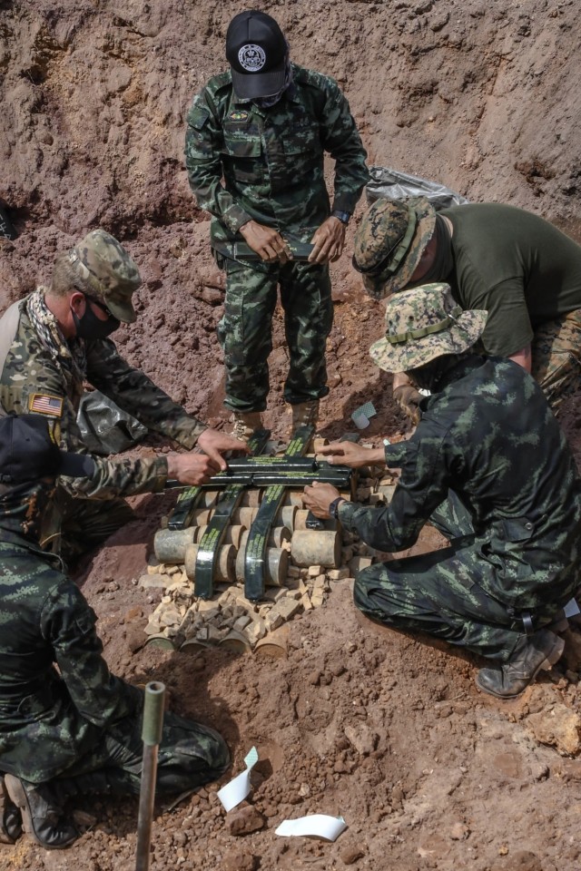 Royal Thai and U.S. service members place C-4 explosives over M16 and PMD landmines for large scale detonation during Exercise Cobra Gold 21 at Ta Mor Roi training area in Surin Province, Thailand, Aug. 7, 2021. Royal Thai and U.S. Armed Forces...