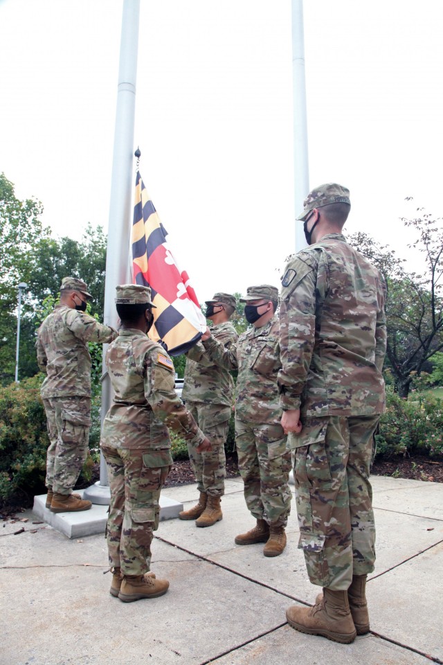 Soldiers from the 21st Signal Brigade at Fort Detrick take part in the annual tradition of raising the American Flag on the first day of school at Whittier Elementary in Frederick, Aug. 18.