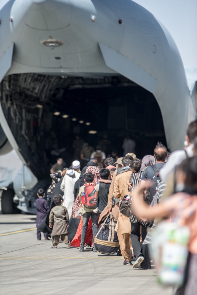 Families board a U.S. Air Force Boeing C-17 Globemaster III  during an evacuation at Hamid Karzai International Airport, Kabul, Afghanistan, Aug. 24. U.S. service members are assisting the Department of State with an orderly drawdown of designated...
