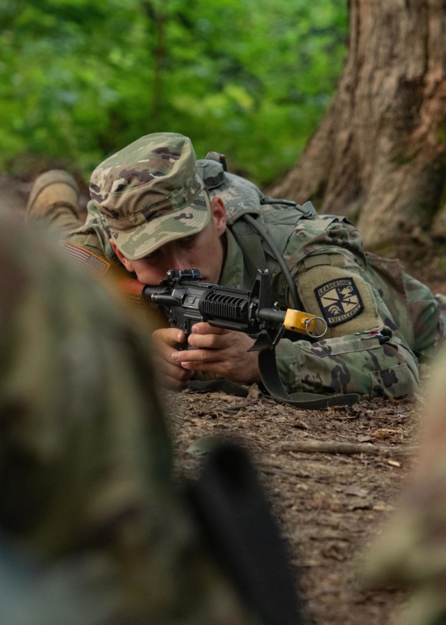 A Cadet practices a hasty fighting position, a security tactic that includes non-verbal commands, while guarding a patrol base, during Field Craft Training in Fort Knox, Ky., on July 21, 2021. | Photo by Olivia Van Den Heuvel, CST Public Affairs