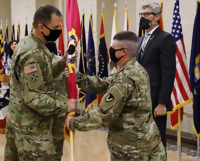 Command Sgt. Maj. Brian Morrison (center right) relinquishes the Joint Munitions Command colors to Brig. Gen. Gavin Gardner (left), JMC commander, at a change of responsibility ceremony August 24. JMC and its 17 subordinate arsenals, depots and ammunition plants produce, store, distribute and demilitarize all conventional munitions for the U.S. Department of Defense. The enterprise is accountable for $59 billion of munitions and missiles (U.S. Army photo by Shawn Eldridge).