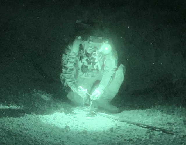 A U.S. Army Explosive Ordnance Disposal technician defeats a mock explosive device in the landing zone for an improvised ribbon bridge on Fort Riley, Kansas. Soldiers from the Fort Riley, Kansas-based 774th Ordnance Company (EOD) and 630th...