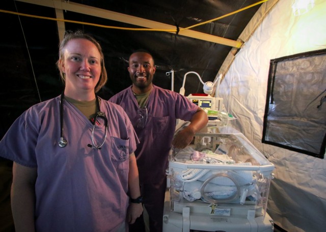 RAMSTEIN AIR BASE, Germany - (From left) U.S. Air Force Maj. Kristin Blouin, neonatal nurse, Neonatal Intensive Care Unit, Landstuhl Regional Medical Center, and native of Tennessee Colony, Texas, and U.S. Air Force Staff Sgt. Lamaar Melvin, aerospace medical technician, Labor and Delivery, LRMC, and native of Newburgh, New York, were part of an obstetrics team which responded to an Afghan evacuee newborn delivery which occurred minutes after an aircraft landing, which transported the evacuee, at Ramstein Air Base, Germany. The team, part of U.S. Armed Forces medical efforts in response to the Afghanistan evacuations, is one of many 24/7 medical teams staged at Ramstein Air Base, which has transformed itself into the logistical hub for the evacuation of people from Afghanistan in less than a week.