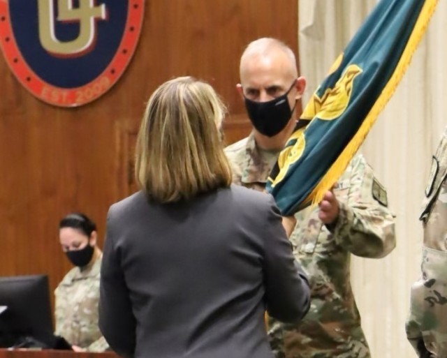 Col. Gregory K. Gibbons accepts the Army Logistics University colors during a change of commandant ceremony Aug. 19 in Bunker Hall’s Green Auditorium. ALU President Sydney A. Smith presided over the formalities. Gibbons previously served as the 50th commander of Letterkenny Army Depot, Chambersburg, Pennsylvania.